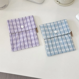 Detail of blue and purple plaid cotton sanitary storage bags with button closure