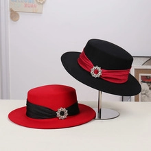 Close-up of leopard print flat top caps with rivet leather bands and crystal brooches