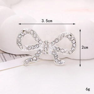 Detailed view of silver rhinestone bow charm with 3.5cm x 2cm dimensions and 6g weight