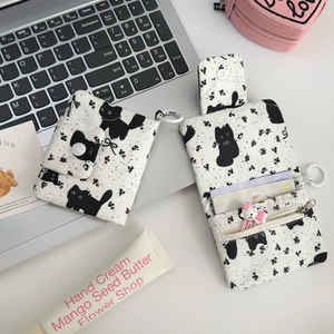 Close-up of floral cat coin purse showing open card slots and zipper pocket detail