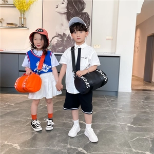 Detail of kids sport cylinder crossbody bag with durable black straps and white SPORT text