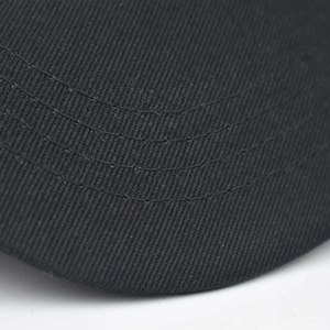 Detailed close-up showing four parallel stitching rows on black cotton twill cap brim