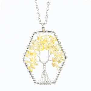 Detail of handmade Tree of Life necklace with yellow crystals in a hexagonal frame
