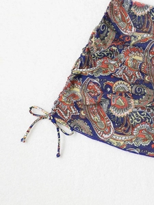 Close-up of paisley print fabric with adjustable drawstring ties on swimwear