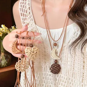 Bohemian long woven heart pendant necklace with natural wood beads and straw accents