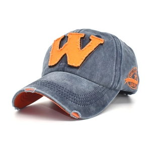 Detail of vintage washed cotton baseball cap with orange W patch and distressed embroidery