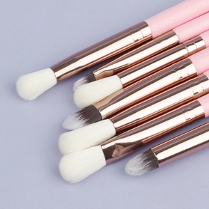 Close-up of 7pcs eye makeup brushes with pink handles and rose gold metal ferrules