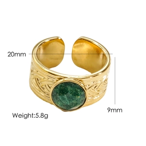 Detail view of gold ring with green gemstone showing 20mm diameter and 9mm width