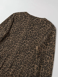 Detail of the leopard print knit fabric showing the round neck and soft texture