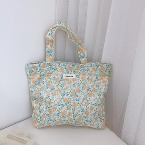 Floral canvas tote bag with simple wish label and orange blossom pattern in bright setting