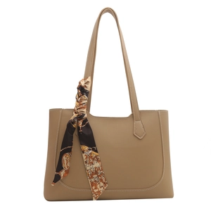 Khaki leather tote bag with vintage printed silk scarf on handle for modern women