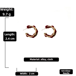 Detail view of gold metal and red fabric earrings with size and weight specifications