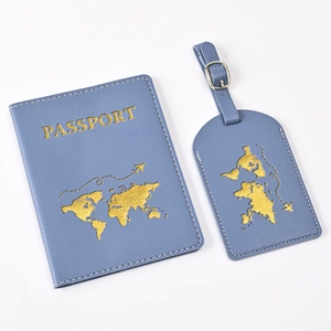 Close-up of blue PU leather passport holder and luggage tag with gold world map design