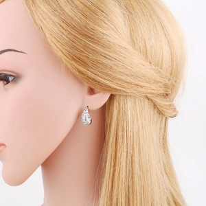 Detailopname van druppeloorbellen met gekleurde zirkoonstenen bij een model