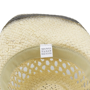Detail view of woven straw hat interior with 100% paper tag and elastic sweatband
