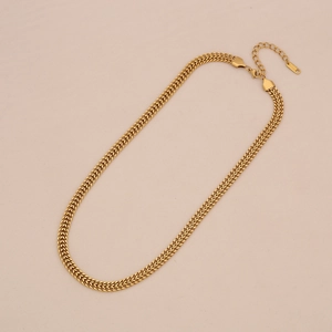 Detail view of gold layered snake and Cuban chain necklace with secure lobster clasp