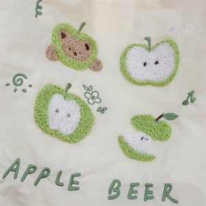 Close-up of high-quality puppy and apple loop embroidery on a cream fabric tote bag
