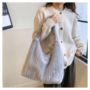 Detail of grey plush hobo bag with vertical ribbed texture and soft faux fur material