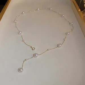 Elegant gold Y-shaped pearl necklace for women featuring multiple white pearls on a thin chain