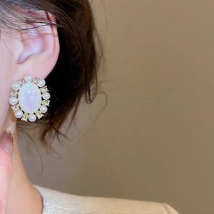 Detail of vintage flower cluster earrings with oval mother-of-pearl and small pearls