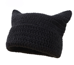 Detail view of the chunky knit texture and cat ears on this black crochet beanie