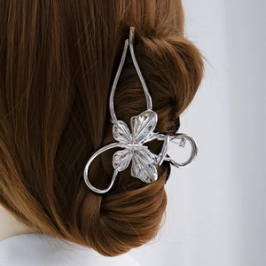 Elegant large silver metal butterfly hair claw clip on brunette bun hairstyle