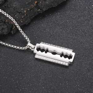 Detailed view of CNC set diamond razor blade pendant on a box chain for men