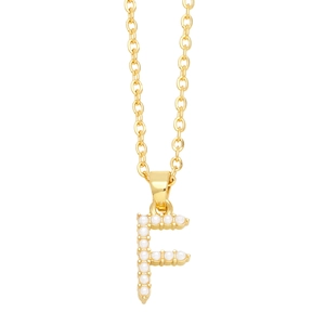 Macro shot of gold letter F pendant with inlaid white pearls on an elegant O-chain necklace
