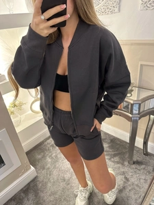 Mirror selfie showing a grey two-piece set with full-zip jacket and matching drawstring shorts