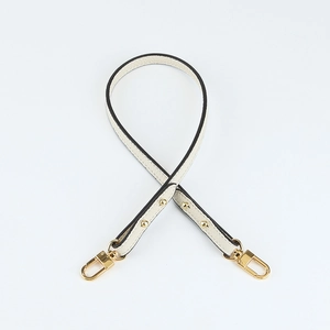 Detail view of lychee pattern leather short strap in cream white with gold metal clasps