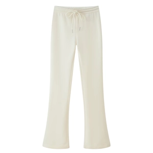 Detail of cream white flared knit pants with elastic drawstring waistband on white background