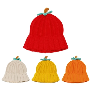 Detail of pumpkin-shaped knit hats in red, cream, yellow, and orange with green leaf accents