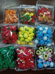 Detailed view of silicone cartoon cable protectors in assorted fruit and animal shapes