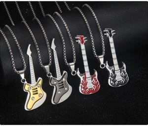 Close-up of four guitar pendant necklaces in gold and silver with flame patterns