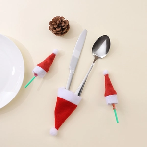 Mini Christmas hats used as cutlery holders and lollipop toppers for holiday table decor