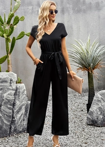 Full shot of black V-neck short sleeve jumpsuit with waist tie and wide-leg trousers