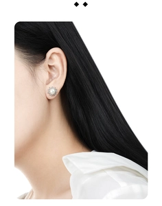 Close-up of elegant S925 silver lava pearl stud earrings worn by a model in soft light