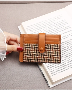 Brown leather and houndstooth pattern accordion card holder with snap button detail