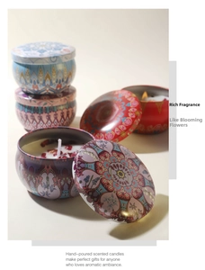 Detail of four handmade soy wax scented candles in bohemian tin jars with dried flowers