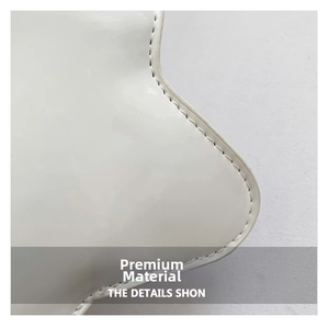 Detail shot of white patent leather star bag with premium stitching and glossy finish