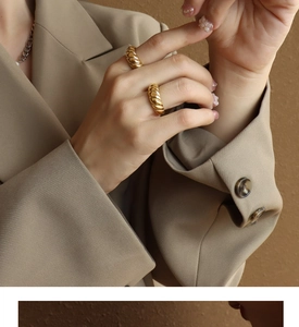 Detailed view of stackable thick twisted rope texture rings in 18k gold plated finish