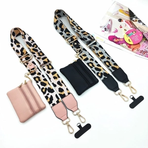 Close-up of leopard print crossbody straps with matching leather coin purse and gold hardware