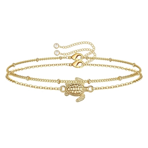Close-up of golden turtle charm and beaded chain with adjustable lobster clasp