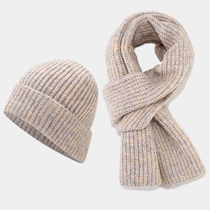 Detail of beige-grey thick knit hat and scarf set showing textured blend fabric