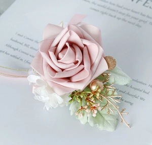 Detailed view of handmade pink PE rose boutonniere with golden berries and satin ribbon
