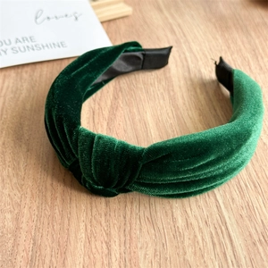 Detail of dark green velvet knotted headband with soft vertical ribbed texture