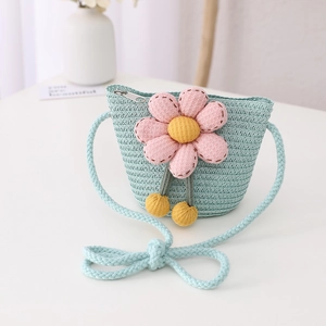 Detail of light blue straw crossbody bag for kids featuring a large 3D pink flower decoration