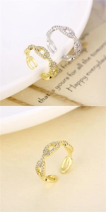 Close-up of gold and silver twist rings featuring micro-pave cubic zirconia crystals