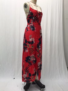 Detail of red floral print maxi dress with high slit and slim fit strap design on mannequin