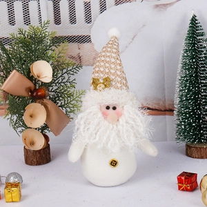 Festive white and gold Christmas gnome plush decoration on a seasonal holiday tabletop